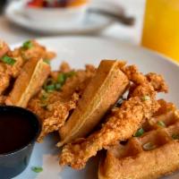 Chicken and Waffles · Golden fried chicken breast served on two Belgian waffles topped with bacon maple buffalo sa...