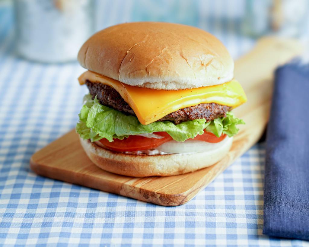 Cheeseburger · A 1/3lb. all beef patty served on a toasted bun with tomatoes, lettuce, onions and dressing. Comes with two thick slices of melted cheese.