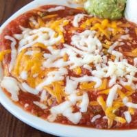 Huevos Rancheros Plate · Corn tortillas topped with 2 eggs,fresh salsa and cheese. Served with refried beans, sour cr...