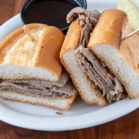 French Beef Dip Sandwich · Thin slices of homemade roast beef piled on our French roll with au jus. Served with your ch...