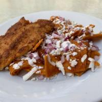 Chilaquiles c/ Milanesa de Pollo · Chilaquiles in red or green sauce, topped w/  Chicken Milanese. This dish is accompanied by ...