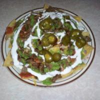 Nacho Grandes · Served with beans, cheese, salsa, guacamole, sour cream and jalapenos with choice of meat.