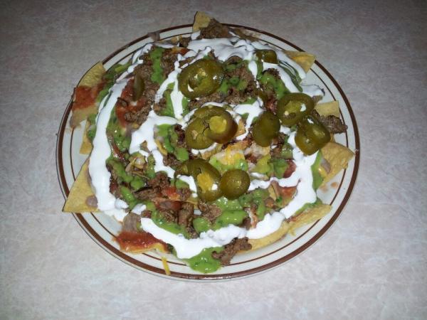Nacho Grandes · Served with beans, cheese, salsa, guacamole, sour cream and jalapenos with choice of meat.