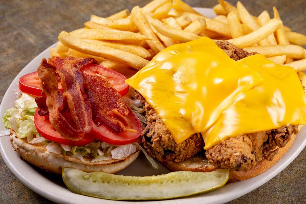 Chicken Club Sandwich · Fried 8oz. chicken breast, bacon, American cheese, lettuce, tomato and mayonnaise served on a bun with a side of fries