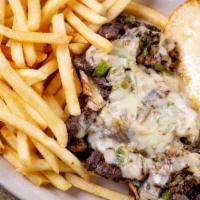 Philly Steak Sandwich · Grilled sliced prime rib topped with grilled onions and grilled bell peppers, Swiss cheese a...