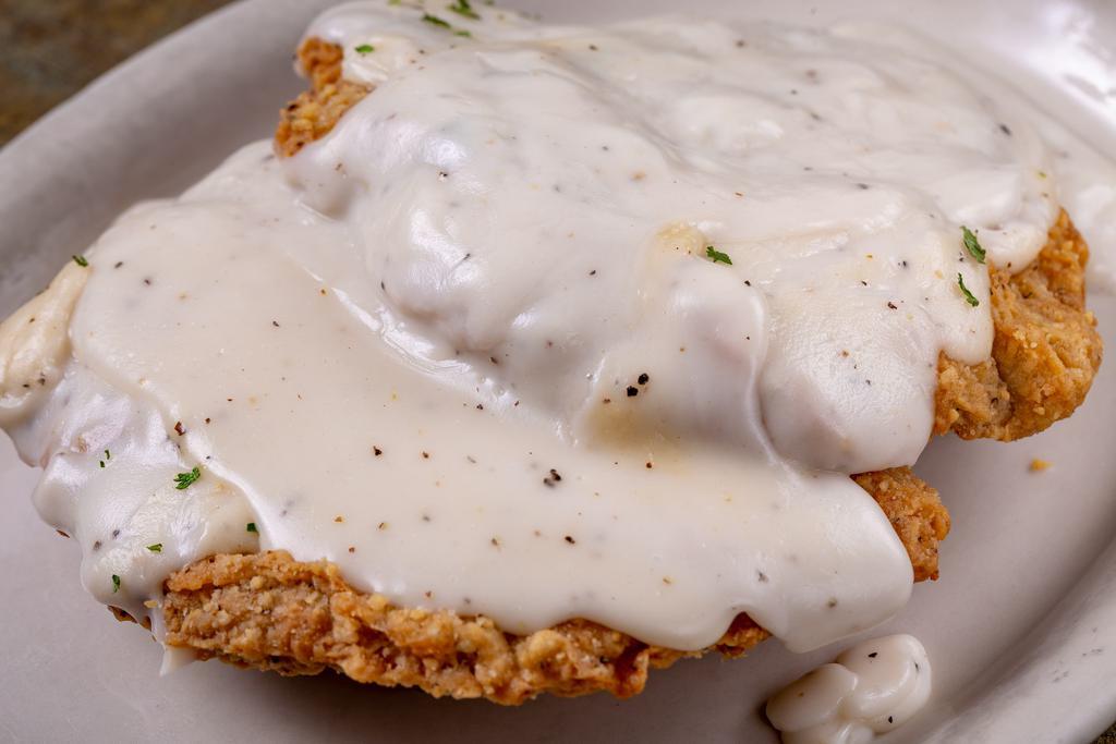 Country Fried Steak · Country fried steak topped with white pepper gravy. Served with your choice of side and a salad.