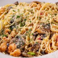 Crawfish Pasta · Sautéed crawfish and mushrooms in a lemon butter wine sauce over pasta. Served with a side s...