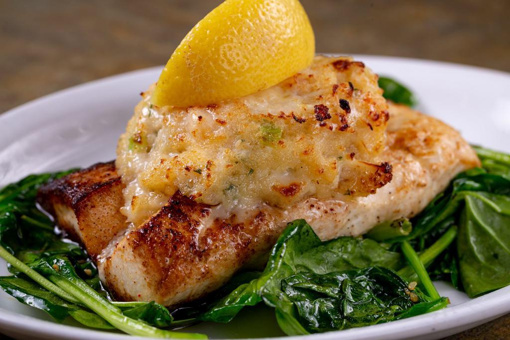 Mahi-Mahi Marliene · Pan seared Mahi topped with a stuffing of crabmeat, shrimp and scallops served over a bed of fresh sauteed spinach.