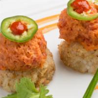 Spicy Tuna on Crispy Rice · Spicy tuna mix on crisped rice, chives, cilantro and jalapeno.