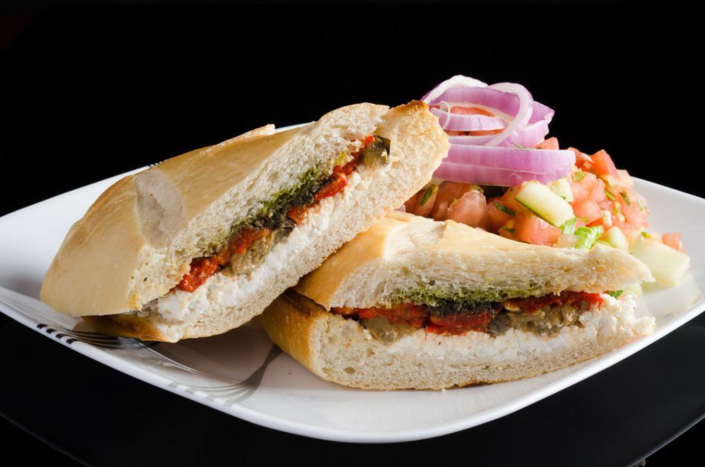 Goat Cheese Sandwich · Goat cheese, roasted eggplant and peppers, olive spread and pesto.