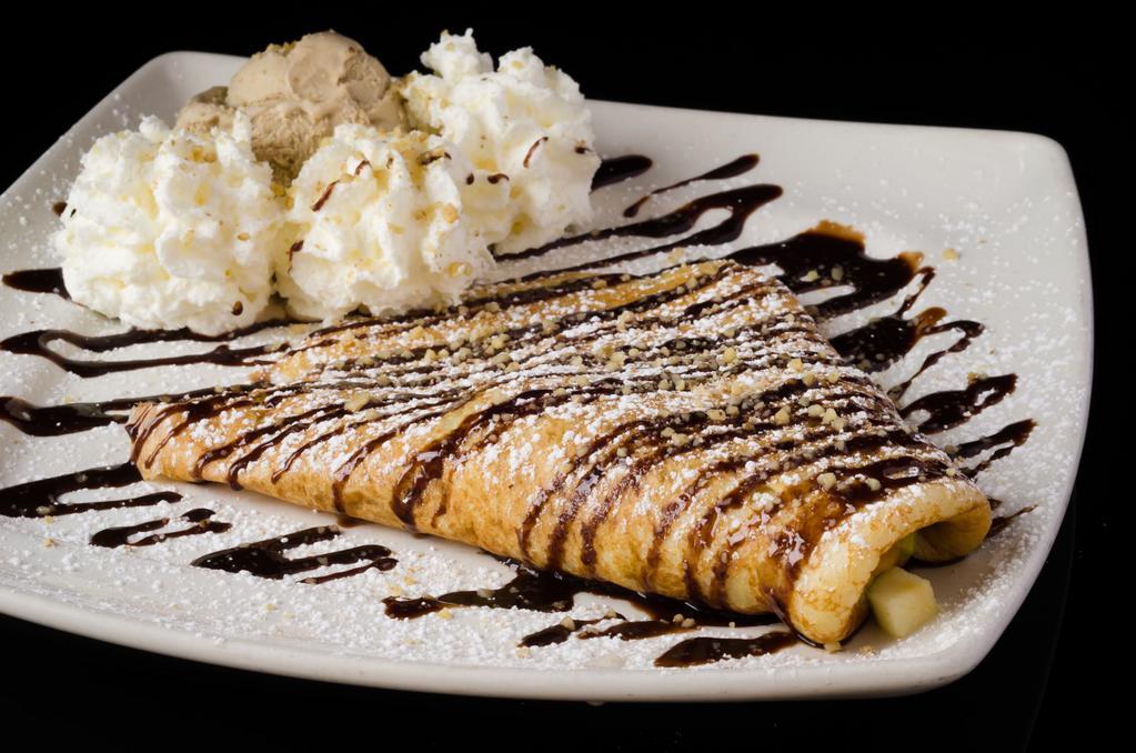 French Crepe · Filled with vanilla flan and hazelnut chocolate spread topped with chocolate, powdered sugar. Served with ice cream and whipped cream.