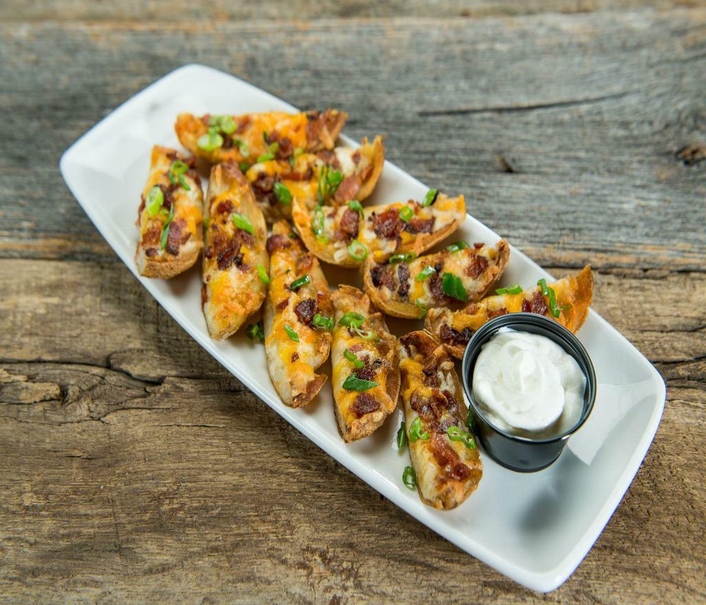 Potato Skins · Hot potato skins loaded with cheddar jack cheese, bacon and scallions. Served with sour cream.