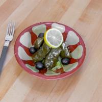 Veggie Dolmathes  · 5 pieces. Grape leaves stuffed with rice, pine nuts tomatoes and spices.
