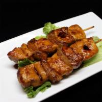 Yakitori · Two skewers of grilled chicken and onion with teriyaki sauce.