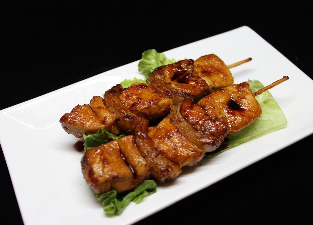 Yakitori · Two skewers of grilled chicken and onion with teriyaki sauce.