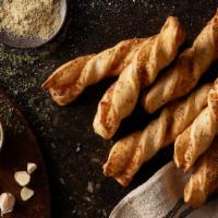 Garlic Parmesan Twists · Our twists are freshly rolled with our signature dough, cheese & garlic, then baked to perfe...