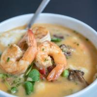 Shrimp and Grits · Sauteed shrimp, mushrooms, bacon, savory gravy, white cheddar grits, pea tendrils.