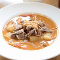 Panang Curry · Simmered medium-spicy red coconut milk, string bean, jalapeno, carrot and lime leaves. Serve...