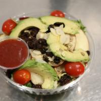 Cancun Salad · Mixed greens, avocado, tomatoes, raisins, apples, almonds, sunflower seeds, & light raspberr...