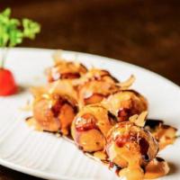Takoyaki · 5 pcs Japanese chopped octopus fritters, served with bonito flakes, katsu sauce & Japanese m...