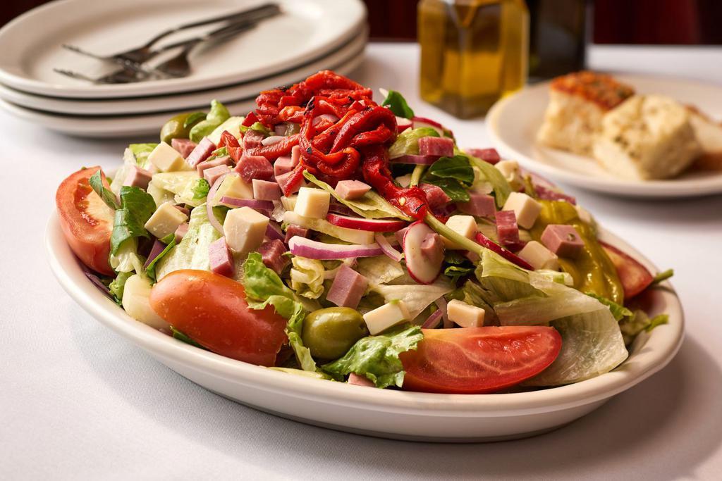 Carmine's Salad · Mixed Greens, Tomato, Onions, Pepperoncini, Celery, Radish, Olives Topped w/ Diced Meats & Cheeses - Served w/ House Vinaigrette Dressing on the Side 