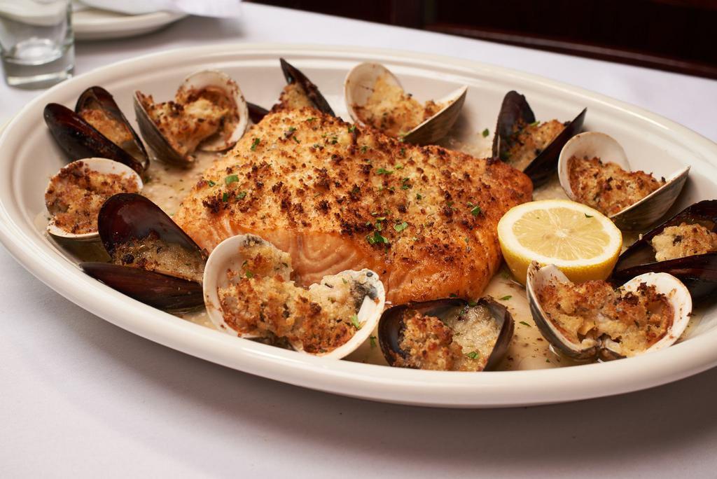 Salmon Oreganata · Salmon Fillet Topped w/ Garlic Butter, Seasoned Bread Crumbs - Broiled & Served w/ a Scampi Sauce, Clams & Mussels