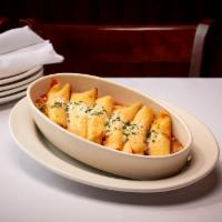 Manicotti · Thin Italian Egg Crepes Stuffed w/ a Mixture of Four Cheeses - Baked Over a Layer of Our Sig...