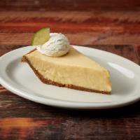 Slice Key Lime Pie · Graham cracker crust filled with fresh key lime and baked topped with fresh whipped cream.