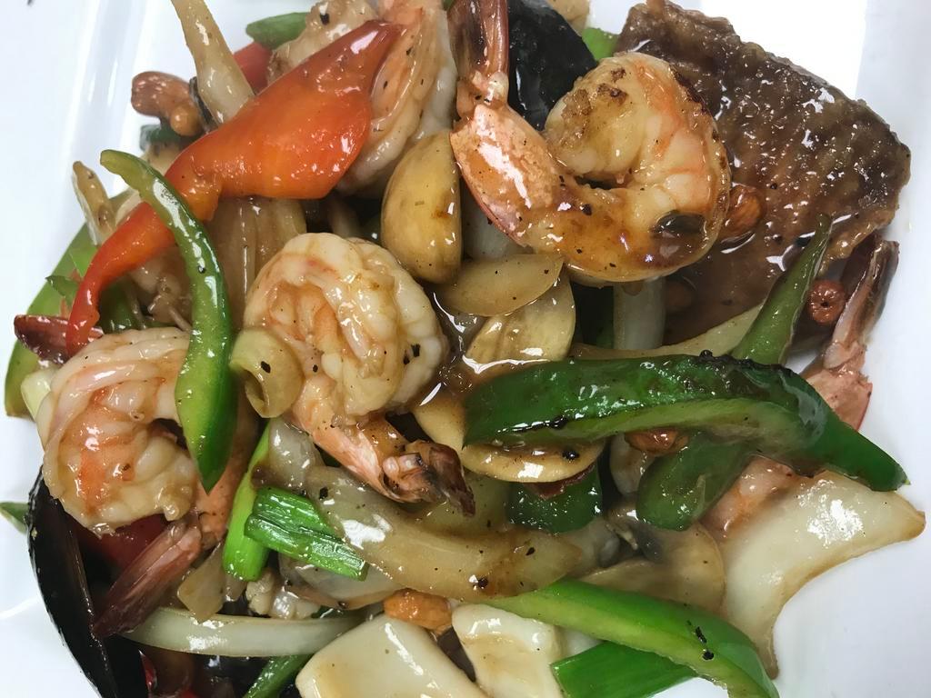 Seafood Black Pepper · With steamed rice. Shrimps, squids, fish, scallop and green mussels with bell pepper, onion, mushroom, cashew nut in black pepper sauce. Spicy.