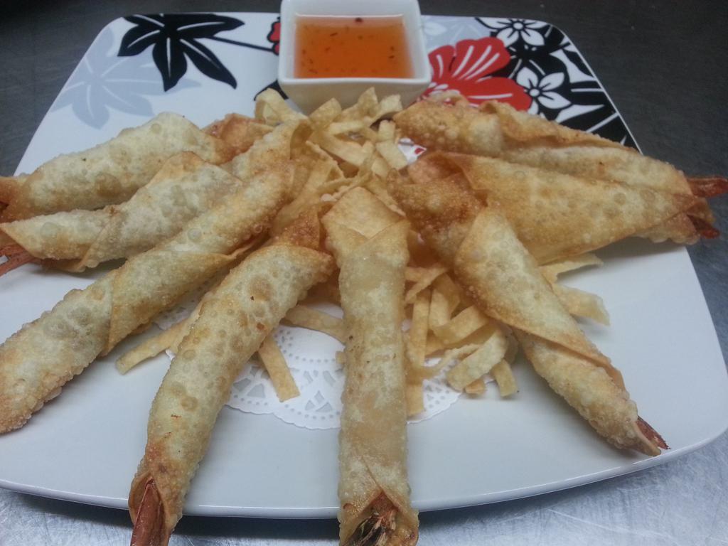 Shrimp Roll · Marinated shrimp wrapped in egg roll skin. Served with sweet and sour sauce.