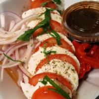 Mozzarella Caprese Salad · Fresh mozzarella cheese, sliced plum tomatoes, sliced red onions, fresh basil drizzled with ...