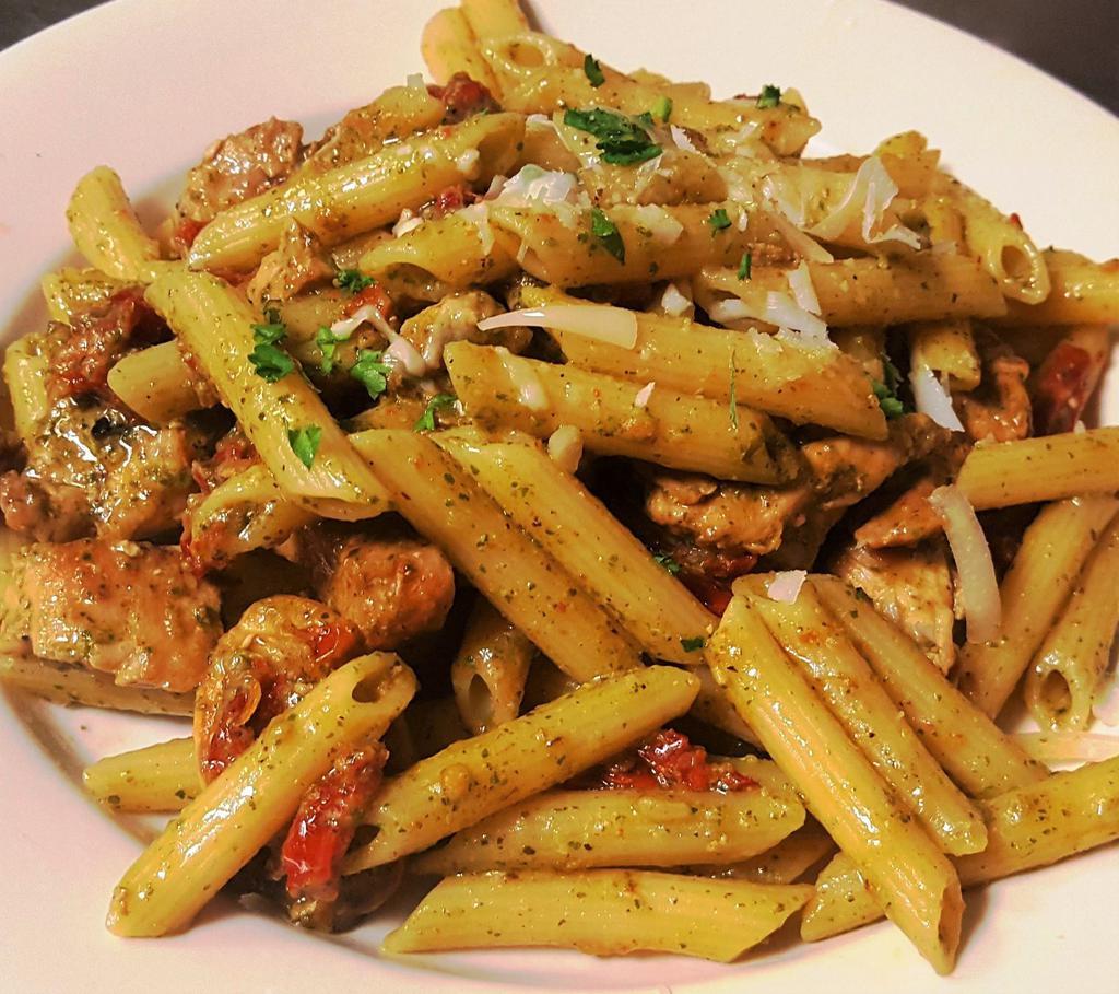 Chicken Pesto & Penne Pasta · Sauteéd sliced chicken breast  with garlic & sundried tomatoes, tossed with pesto sauce & penne pasta. Includes a small, fresh Garden Salad side, dressing, and garlic bread.