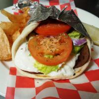 Gyro · Sliced beef & lamb gyro, romaine lettuce, plum tomatoes, fresh red onions and house-made Tza...