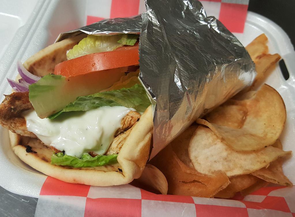 Grilled Chicken Pita · Marinated grilled chicken breast with romaine lettuce, plum tomato, red onion and house-made tzatziki sauce. Served on a pita bread with slice of pickle and house-made potato chips.