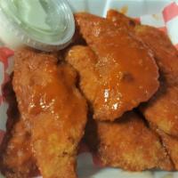 Buffalo Tenders (6) · Chicken tenders tossed in Buffalo sauce served with blue cheese or ranch dip.