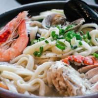 (NON-SPICY) Seafood-KALGUKSU (해물 칼국수) · Hand-cut noodles in anchovy broth with clams, shrimp, 1/2 crab, mussels, potato and green on...