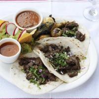 Tacos de Arrachera · Three tacos with grilled skirt steak served on flour tortillas.  Topped w/fresh onions & cil...