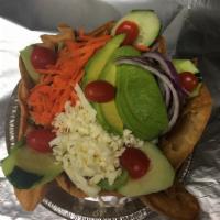 Taco Salad · Mixed field greens, tomatoes, onion, carrots, cucumber, avocado and cheese served in a torti...