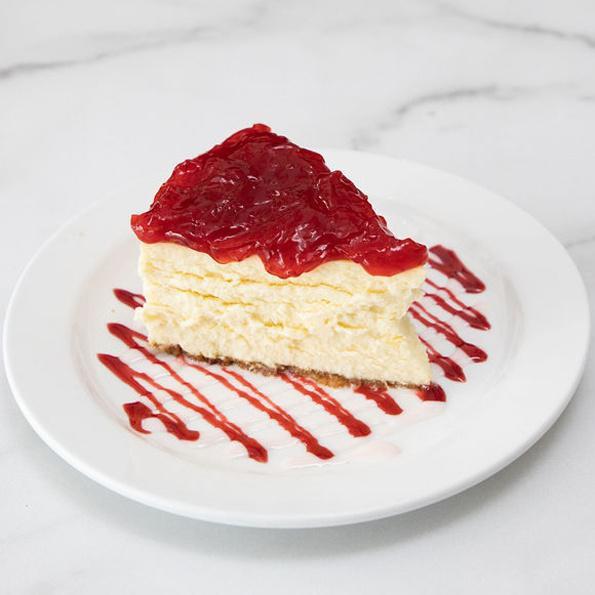 NY Cheesecake, slice · Classic New York Cheesecake with five different toppings to choose from: imported strawberry preserves, lemon curd, blueberry preserves, cherry preserves or fudge. (no nuts)