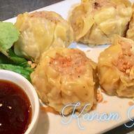 Kanum Jeeb · 5 pieces. Steamed shrimp and sea bass dumplings topped with fried garlic and sweet soy sauce.