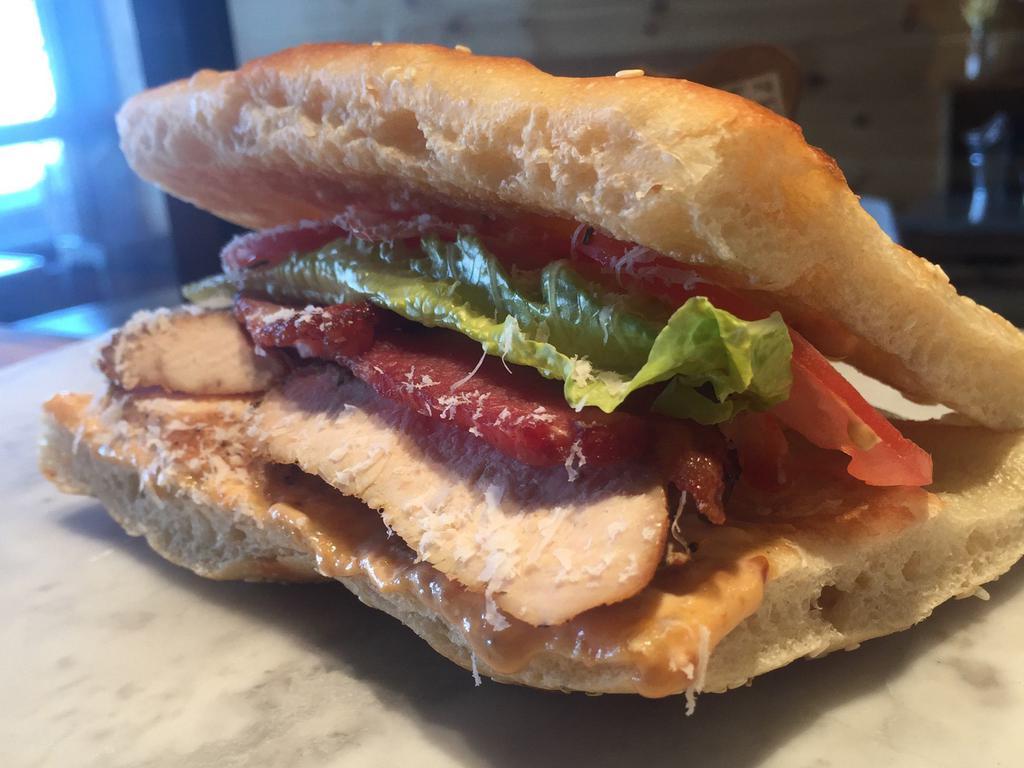 Sierra Sandwich · Grilled chicken, bacon, lettuce and tomatoes, with a roasted tomato and pepper aioli.