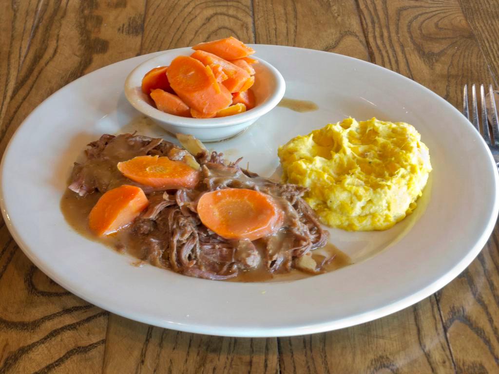 Classic Slow Cooked Pot Roast · We take our time and you can taste it. Our classic pot roast is slow roasted with carrots and onions for hours, then topped with savory brown gravy. Includes your choice of two vegetables.