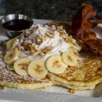 Banana and Walnut Pancakes  · 3 fluffy pancakes made with fresh banana, topped with whipped cream and chopped walnuts.