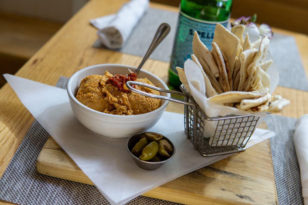 Artichoke Hummus · Homemade, with sun-dried tomato pesto and olives served with pita bread.