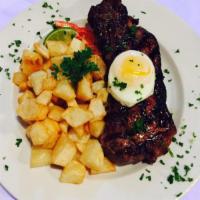 Bitoque Bife  · NY strip topped with fried egg, rice and fried potatoes.