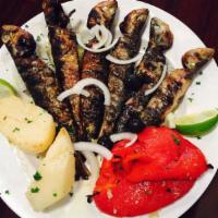 Sardinhas Assadas · Grilled sardines with roasted peppers, onions and roasted potatoes.
