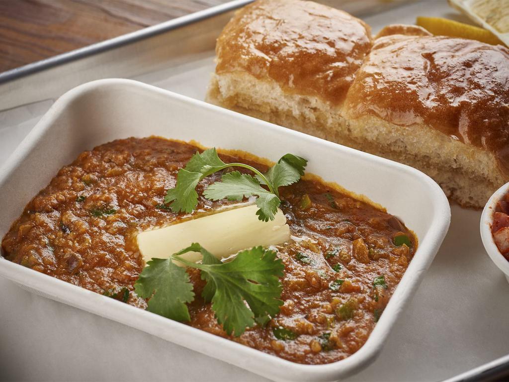 Cheese Bhaji Pav · Vegetable curry with spices topped with cheese served with pav.