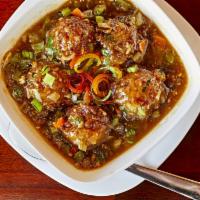 Manchurian Gravy · Deep-fried vegetable dumplings, simmered in Indo-Chinese spices gravy.