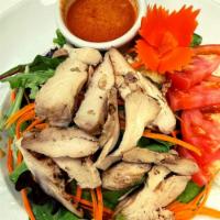 Ploy's Grilled Chicken Salad · Fresh spring mix garden salad with grilled chicken breast on the top served with peanut dres...