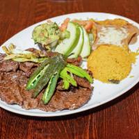 Carne Asada · harbroiled skirt steak served with rice, beans, guacamole and warm tortillas. Garnished with...